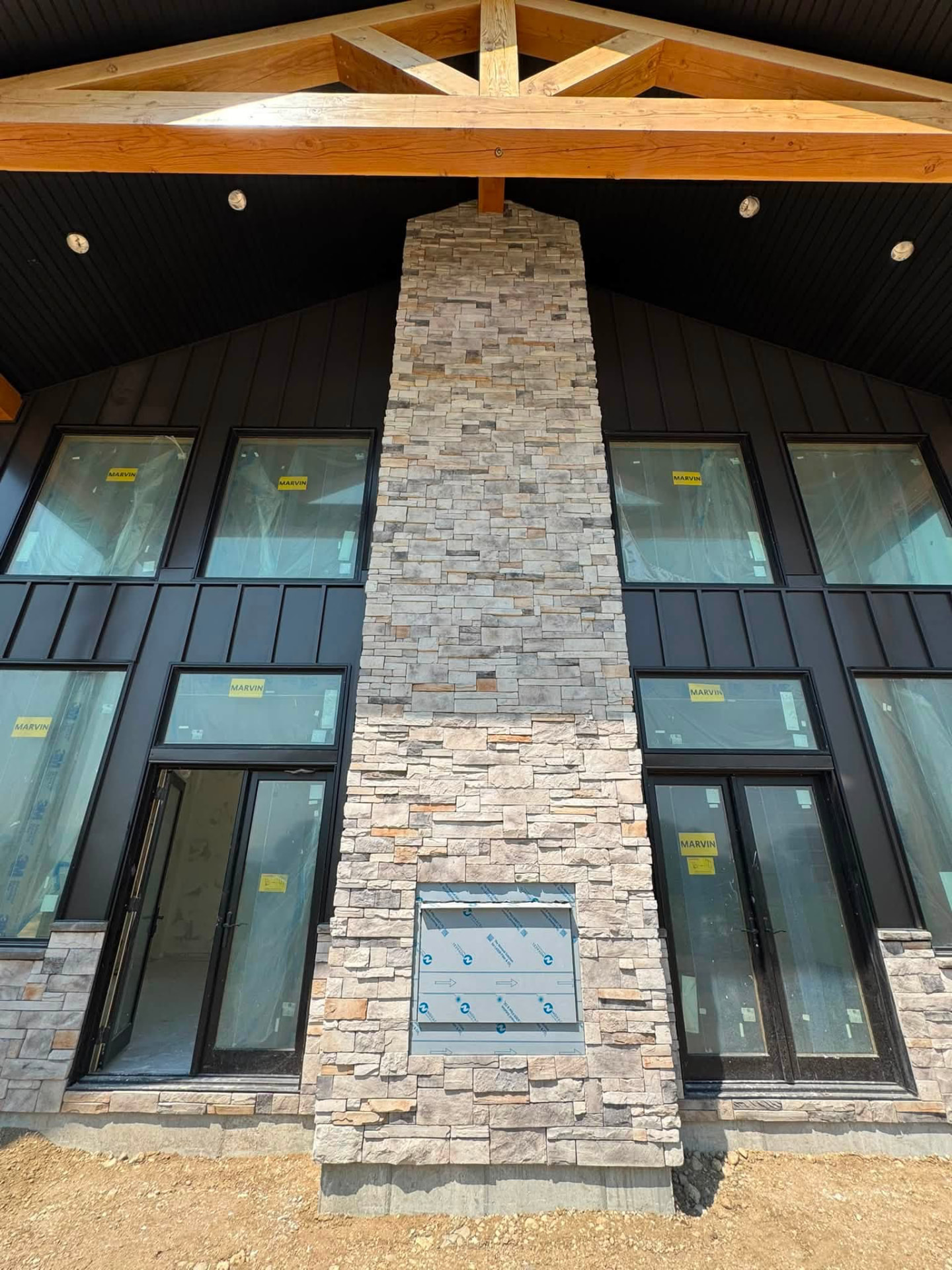 Stone chimney beneath exposed timber beams