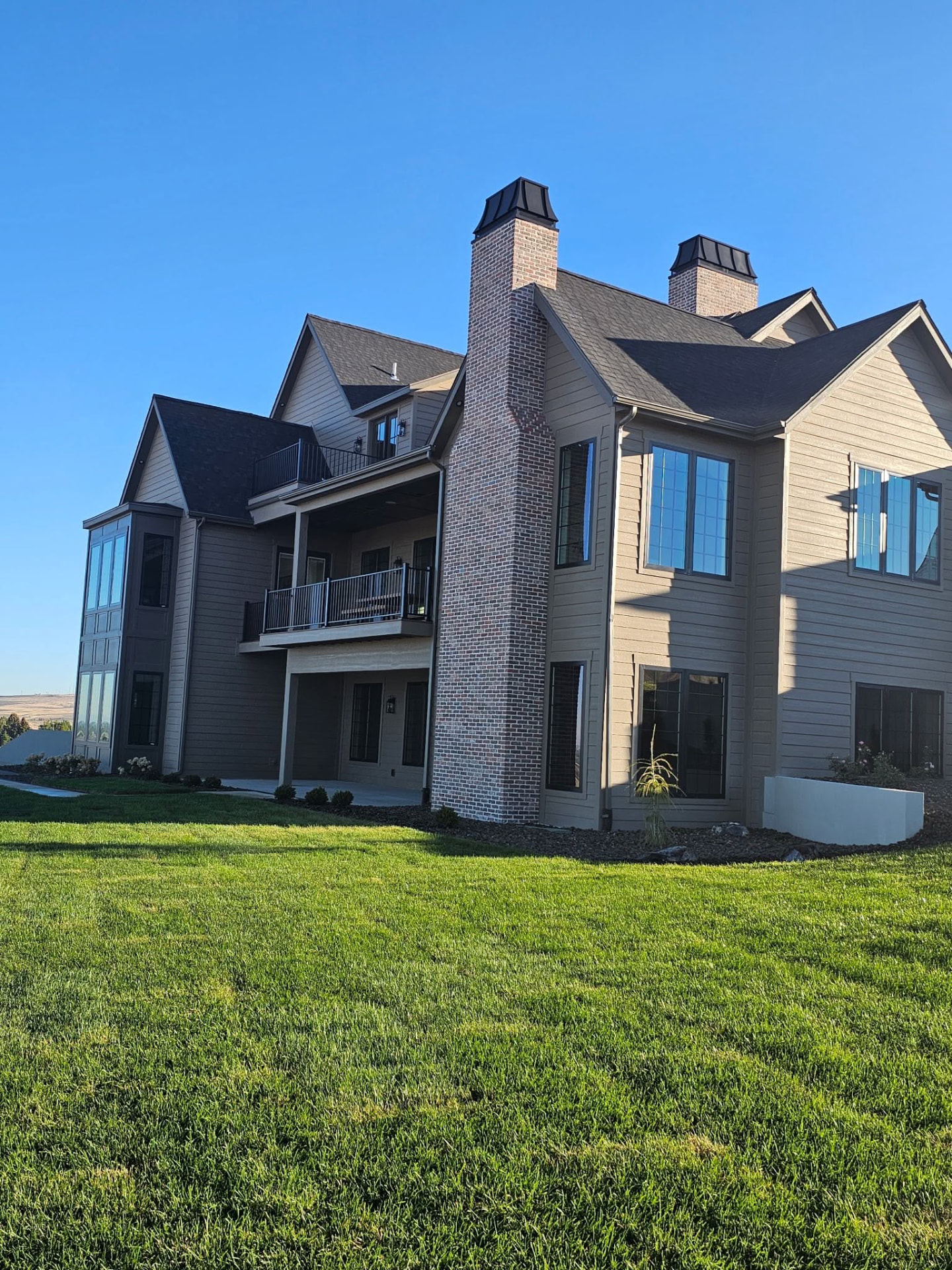 Tall brick chimneys on the rear of a home