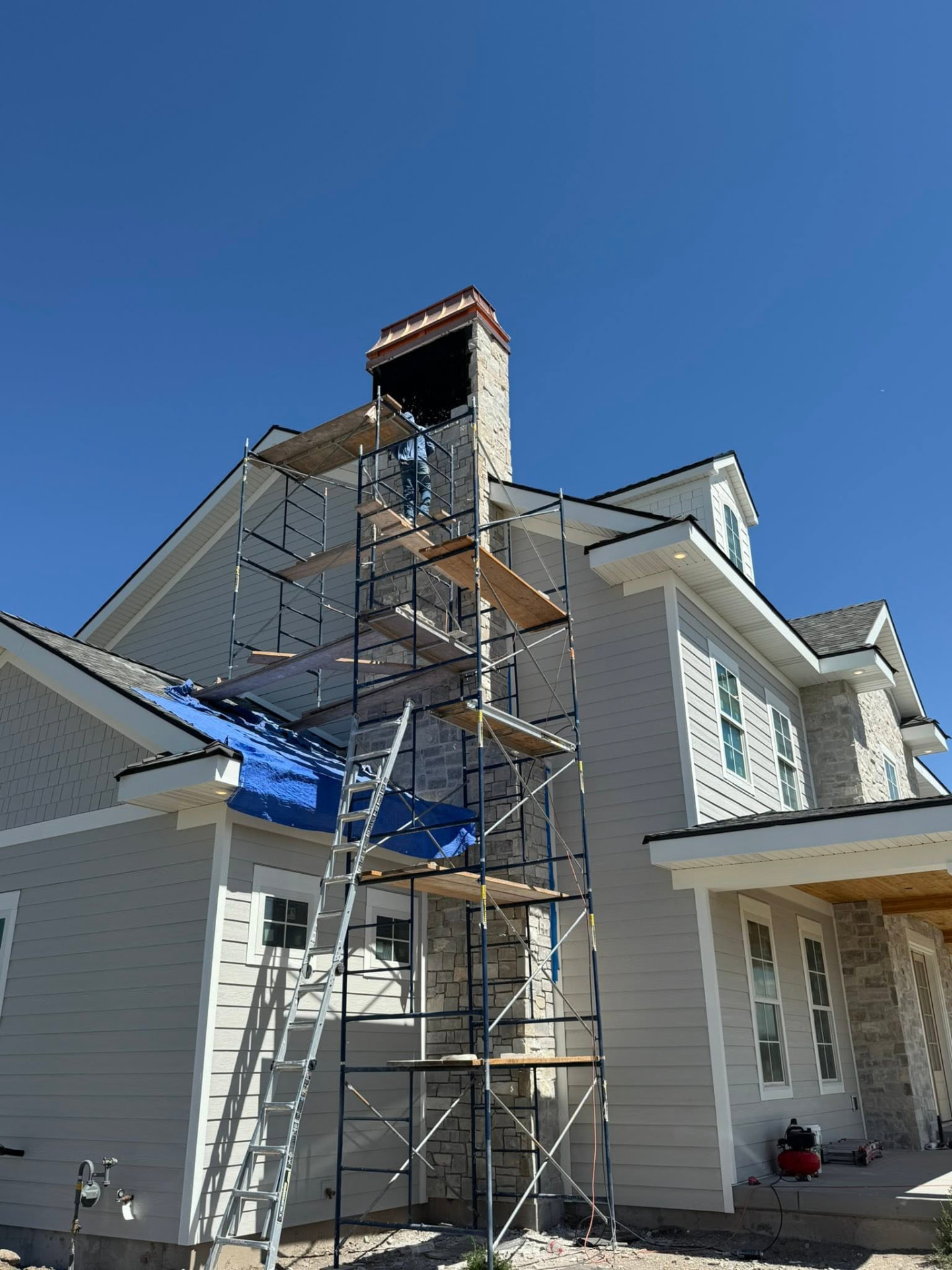 Scaffolding surrounding a chimney during masonry construction